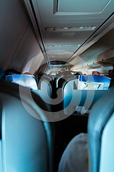 Interior of passenger airplane with people on seats