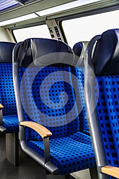 Interior of passenger train with blue empty seats