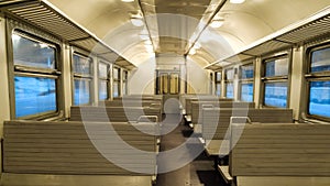 The interior of a passenger train with empty seats