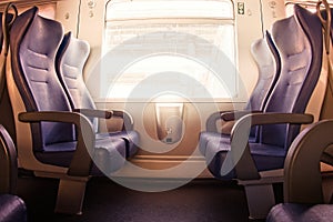 Interior of a passenger train with empty seats.