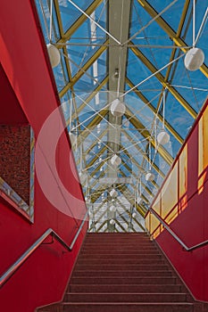 Interior of the pedestrian bridge in red tones in the city of Moscow