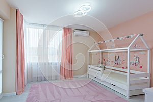 Interior photo children`s room for a girl of light color with pink, with a white cot