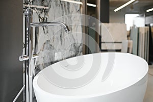 Interior photography of plumbing establishment where tiles, bathtubs, furniture and toilets are sold