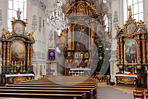 Interior of pilgrimage church golden altars with Christmas tree