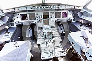 Interior of pilot cabine in actual modern passenger jet airplane Airbus A319. Many buttons,