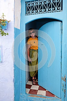 Interior portrait of a middle-aged woman in blue city of  Chefchaouen,Morocco