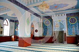 Interior prayer area with blue calligraphy mihrab columns Jumah Central Mosque Tbilisi Georgia