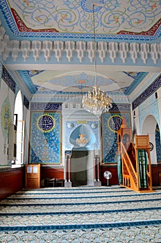 Interior prayer area with blue calligraphy mihrab columns Jumah Central Mosque Tbilisi Georgia