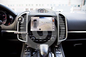 Interior of premium suv, work of front side, side, and rear view camera in 360 degrees system. Help assist options inside luxury