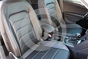 Interior of prestige modern car. Comfortable leather seats. The driver and front passenger seat of a luxury business class car.