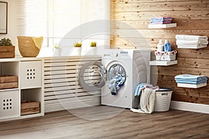 Interior of real laundry room with washing machine at window at