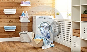 Interior of real laundry room with washing machine at window at