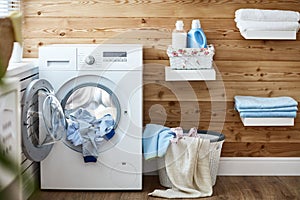 Interior of real laundry room with washing machine at window at