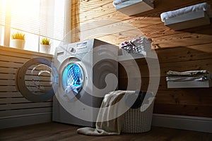 Interior of real laundry room with washing machine at window at