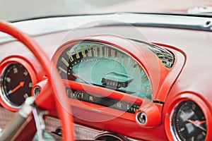 Interior of a red vintage car and speedometer