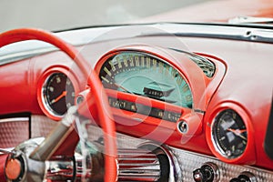 Interior of a red vintage car and speedometer