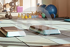 Interior of rehabilitation gym, with equiment: balls, mats, steps