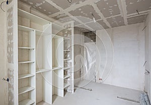 Interior of renovated room with built-in wardrobe