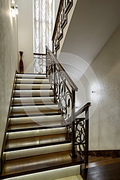 Interior of residential house. Nice staircase with LED lights. Home interior design in modern style