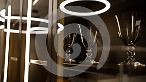 Interior of a restaurant with a server room without people. Beautiful glasses for wine and alcohol are displayed behind