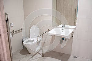 Interior of restroom for elderly people with lavatory toilet bow