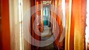 Beautiful interior of retro steam train car with wooden doors and carpets on floor