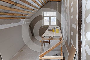 Interior of room apartment with new window and materials home-made scaffold, tools, level during on the renovation, overhaul and