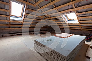 Interior of room apartment with new windows and materials pieces of drywall during on the renovation, overhaul and construction