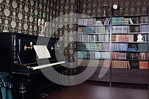 Interior of room with book shelves and piano