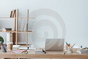 interior of room with copybooks and laptop