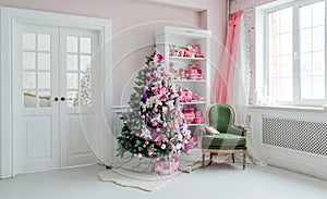 Interior room decorated in Christmas style. No people. An empty green chair. Pink colors. Home comfort of modern house.