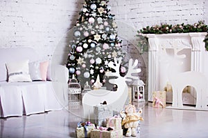 Interior room decorated in Christmas style. No people. Home comfort of modern house. Xmas tree and fireplace