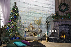 Interior room decorated in Christmas style. Xmas tree decorated by lights, presents, peacock feathers, gifts, candles and garlands