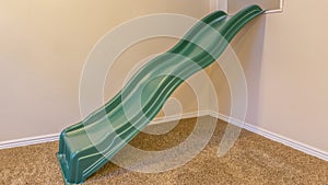 Interior of a room with a green slide for children