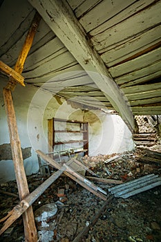 Interior Of Ruined Abandoned Country House With Caved Roof, Evacuation Zone After Chernobyl Disaster