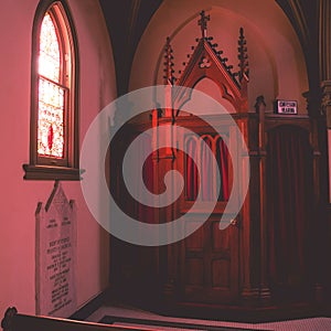 Interior of Saint John the Evangelist catholic church with confessor hearing room in Indianapolis