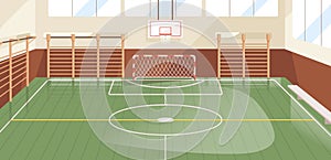 Interior of school gym equipped with basketball hoop, goal and wall bars. Indoor sports hall or court with equipment for