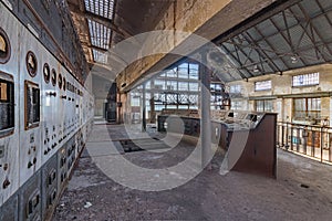 Interior shot of a large control panel in a turbine hall of a historic power plant