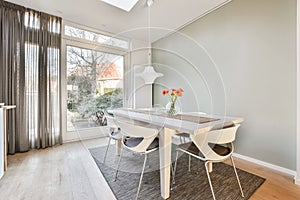 Interior shot of a modern dining room with decorations next to an entrance