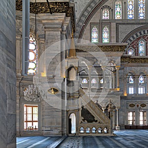 Interior shot of Nuruosmaniye Mosque with minbar platform, arches & colored stained glass windows, Istanbul, Turkey photo