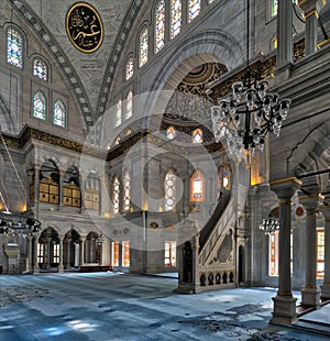 Interior shot of Nuruosmaniye Mosque with minbar platform, huge arches & colored stained glass windows, Istanbul, Turkey