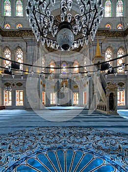 Interior shot of Nuruosmaniye Mosque overlooking niche Mihrab and marble minbar Platform facade, Istanbul, Turkey photo