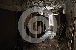 Interior shot of an old abandoned building with rusted wooden doors