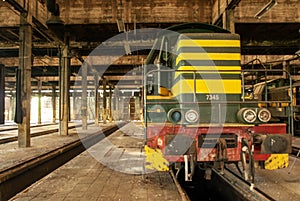 Interior shot of an old abandoned warehouse with an old train inside