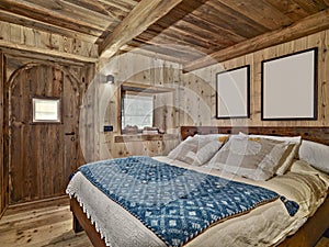 Interior shot a rustic bedroom with wood ceiling and wood walls