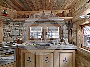 Interior shot of a rustic kitchen in foreground the marble sink