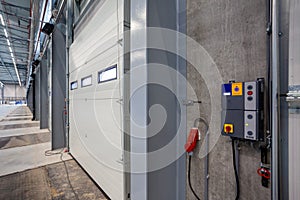 Interior shot of a warehouse with a control panel next to the door