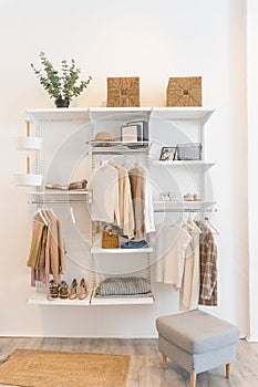 Interior of show room with stylish clothes and accessories.Collection of female clothes hanging on rack in dressing room