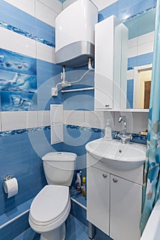 Interior of a small bathroom, toilet, wash basin, boiler