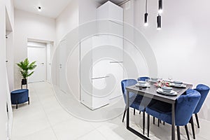 Interior of a small bright kitchen in a small modern apartment with white walls